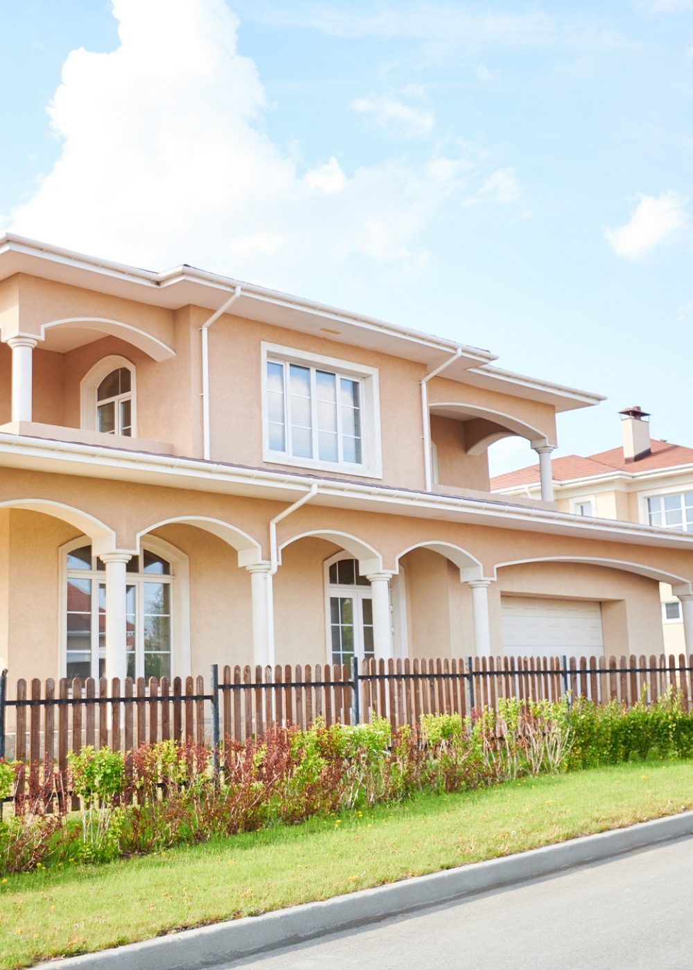 Wide angle shot beautiful two storey house in rich neighborhood, view from road, copy space